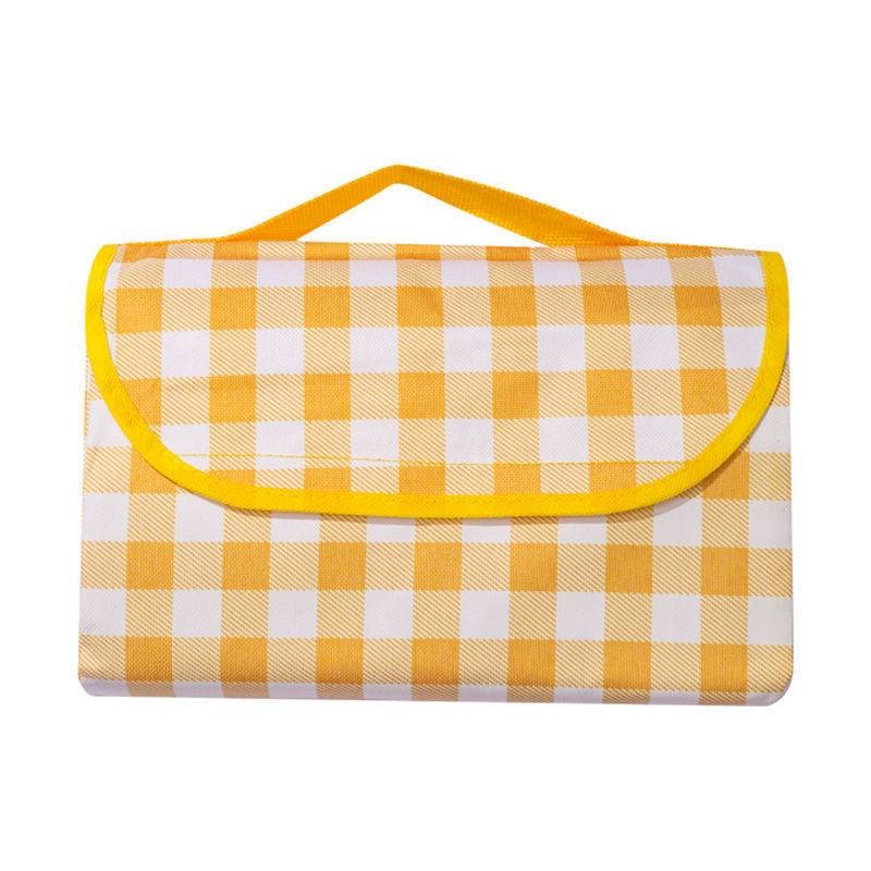 An outdoor picnic pad with a thick camping camping pad on a beach that folds up the rags