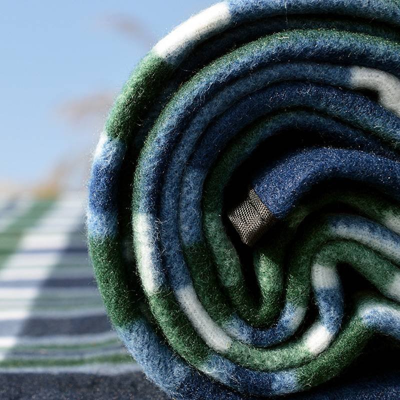 A picnic mat with a thick camping pad for the outdoors