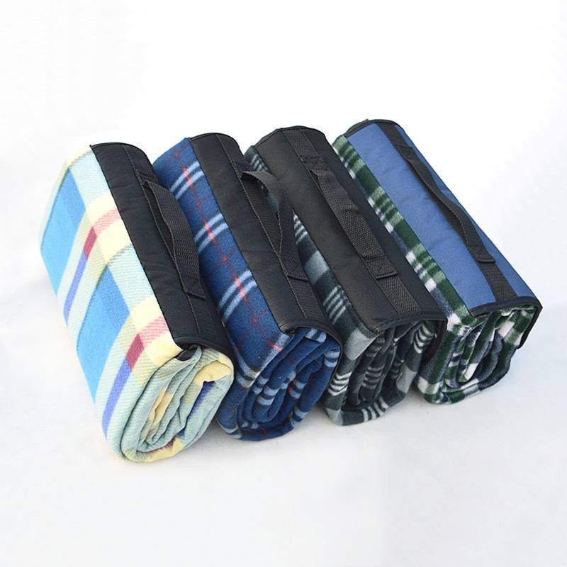 A picnic mat with a thick camping pad for the outdoors