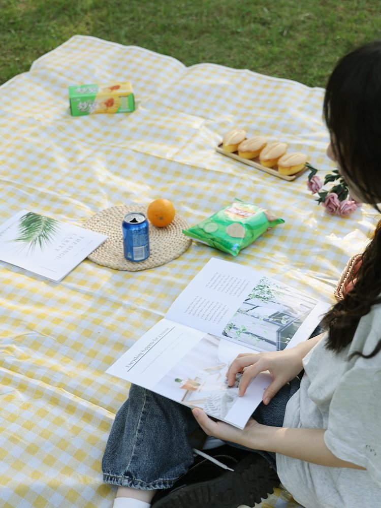 A picnic mat with a thick outdoor camping and a waterproof spring tarpaulin can fold