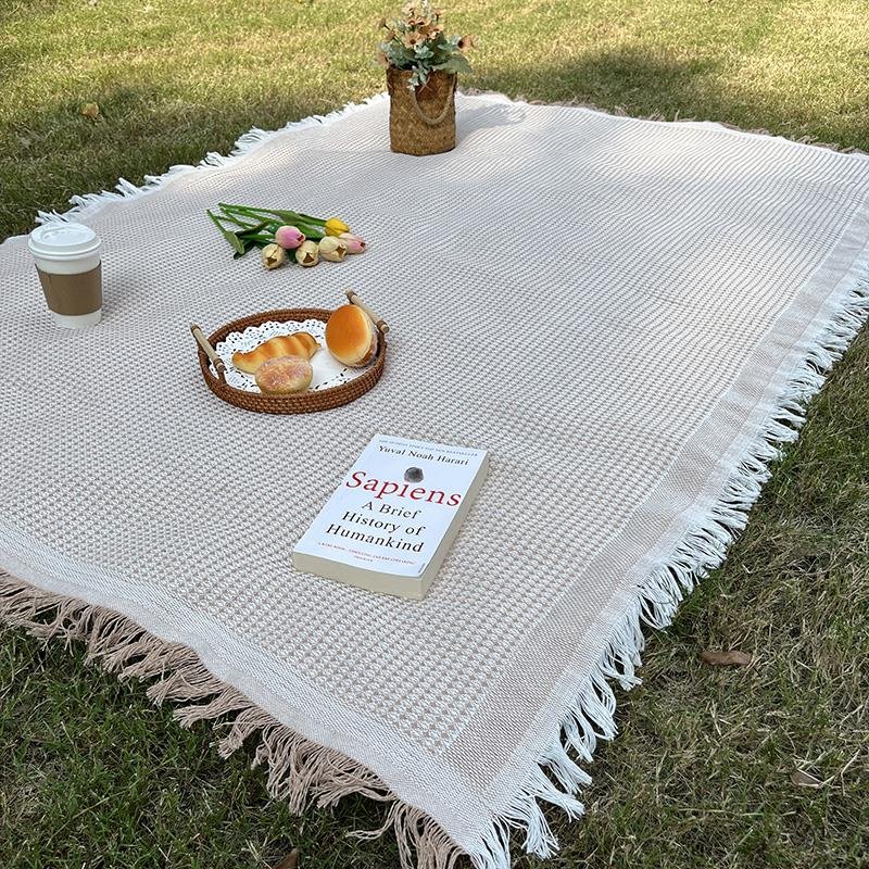 a picnic mat outside the house, with a thicker lawn, and a beach mat for the bonnet music festival