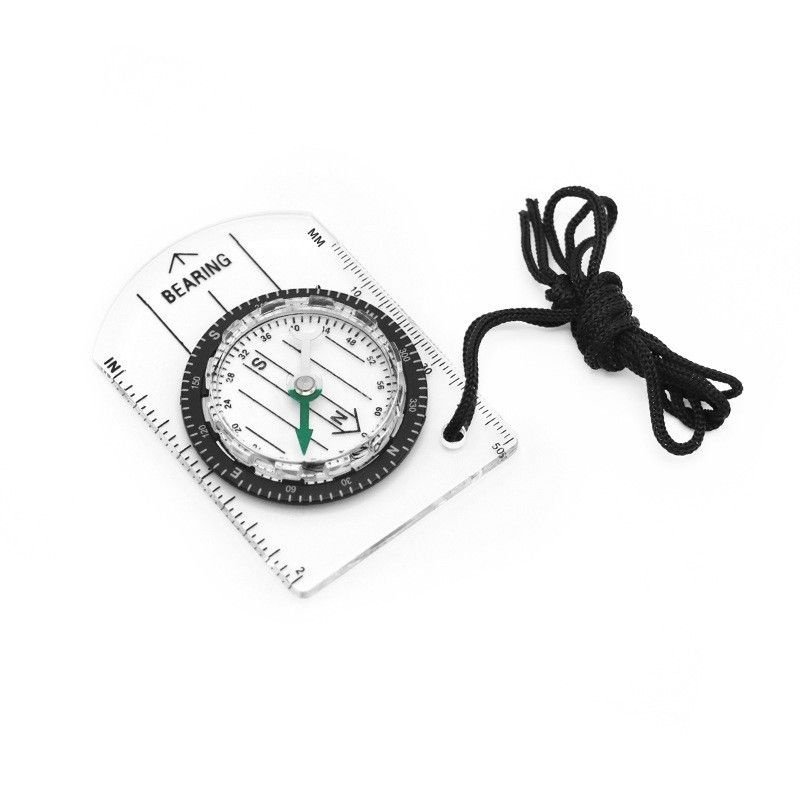A professional multi-purpose compass for outdoor equipment in the wilderness points to a scale-scale compass of the north map