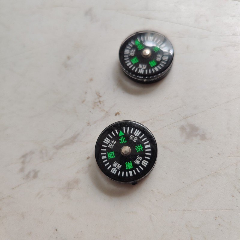 SUZUKI'S UY MOTORBIKE COMPASS, A CYCLIST'S CYCLIST'S RICKET COMPASS, A CHINESE COMPASS MINI
