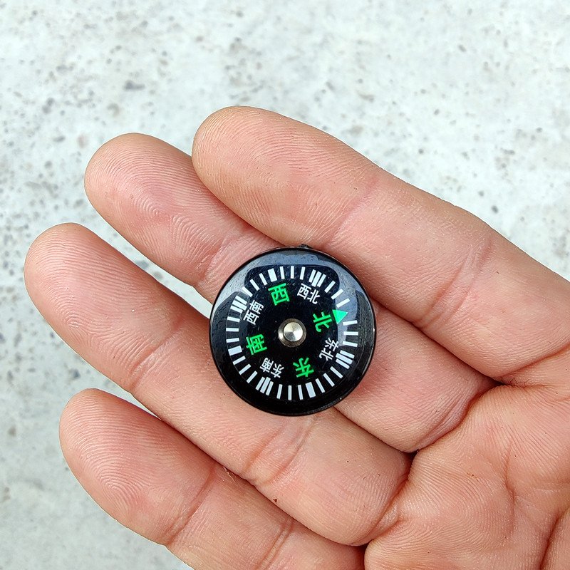 SUZUKI'S UY MOTORBIKE COMPASS, A CYCLIST'S CYCLIST'S RICKET COMPASS, A CHINESE COMPASS MINI