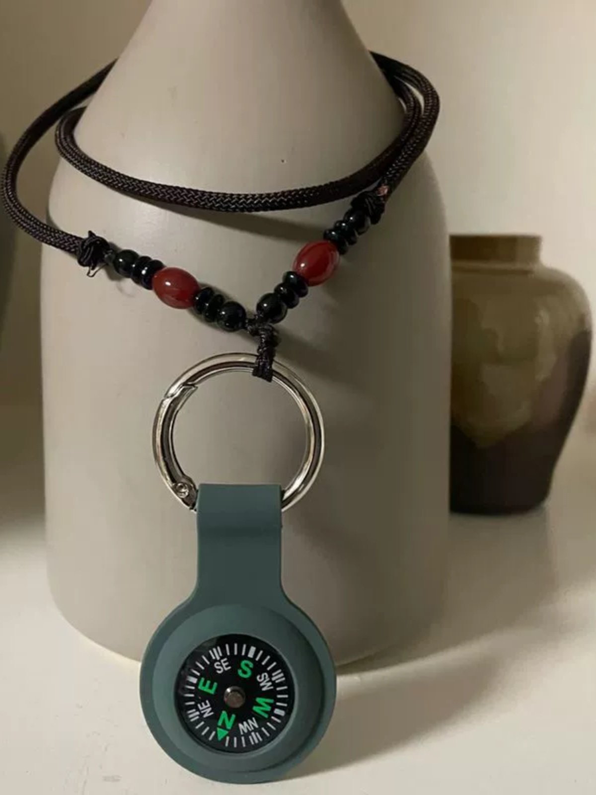 An out-of-door camper key to a necklace child guide student test pointer