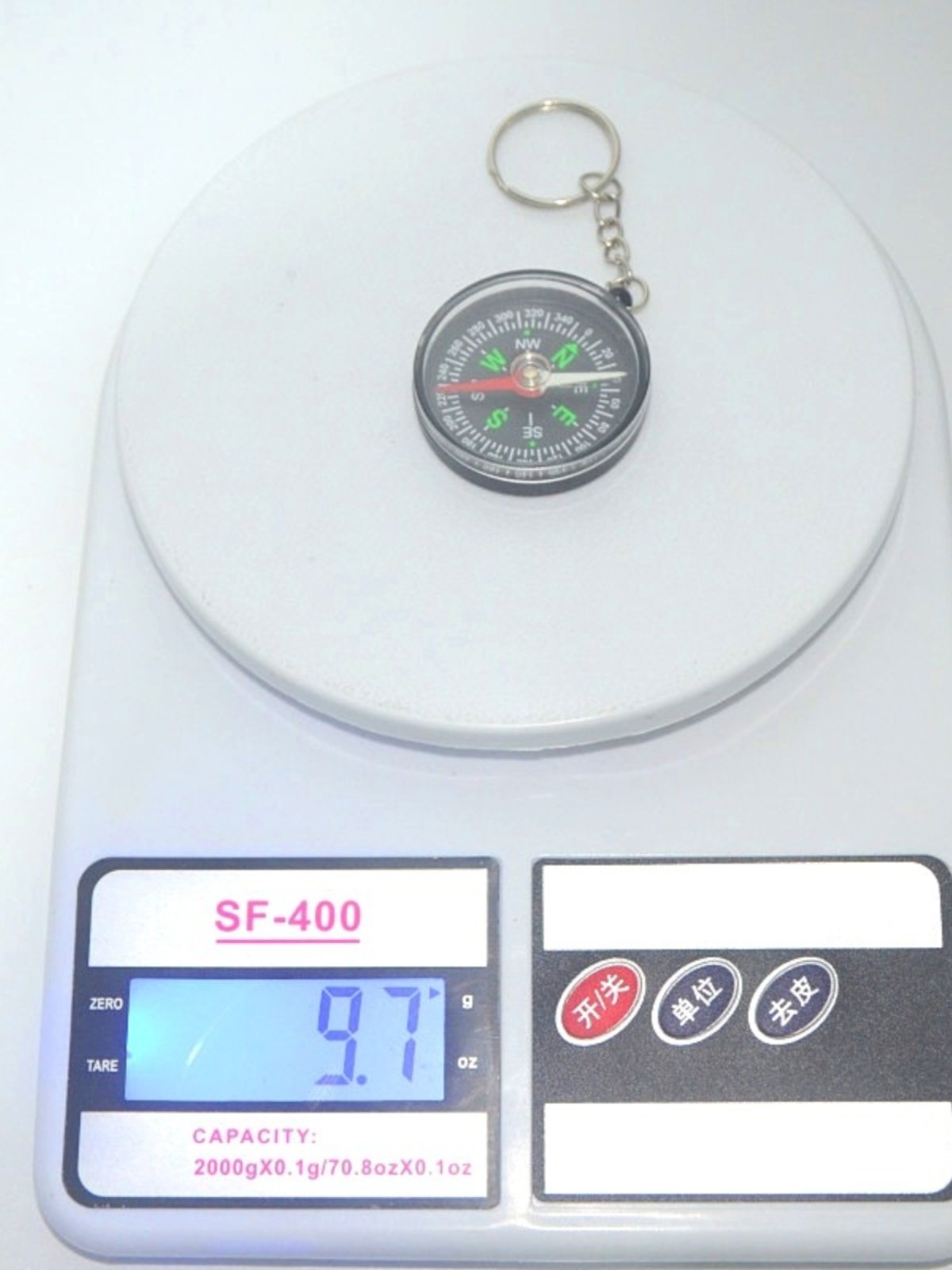 A car compass with a key button for a black student's outdoor school supplies indicates a printable northerly needle