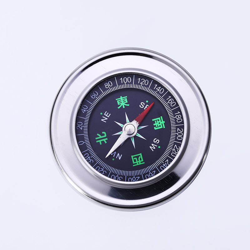 A car-borne compass for a child student pointing a sports compass to the north with a mini-precision outdoor non-night light