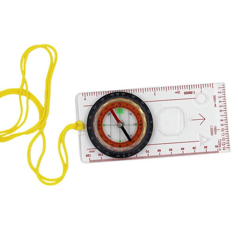 A multi-purpose map ruler guide to a field camping tool points to the north for an emergency