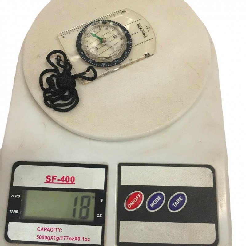 An outdoor multifunctional and transparent portable compass with a map of the compass and a northerly pointer