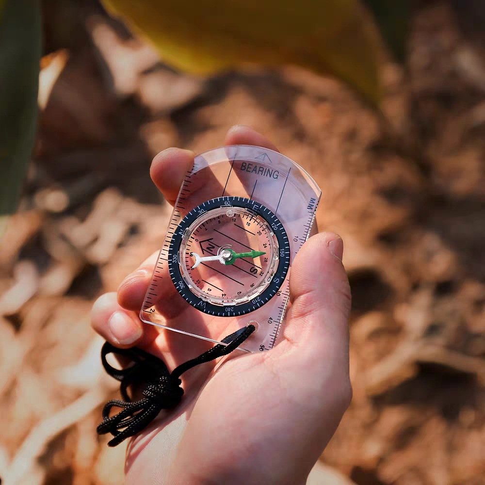 Multi-purpose outdoor mini-students take the emergency compass with a map to survive