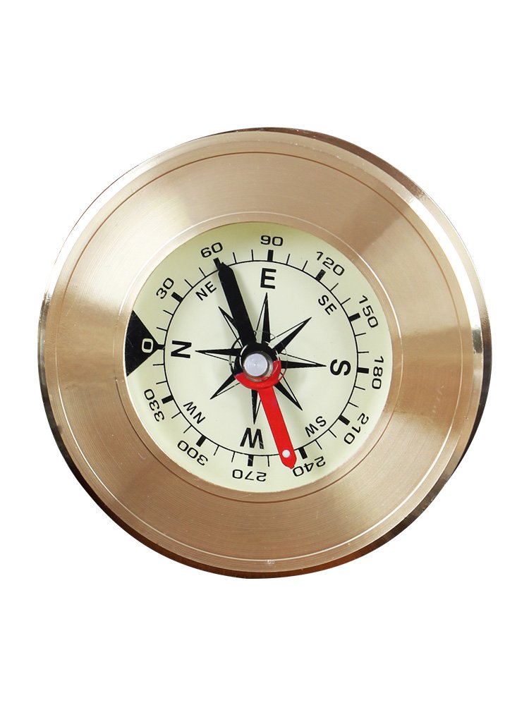 A guided compass with a high accuracy of car supplies in the direction of an outdoor hiking camp pointing to a children ' s compass in the north