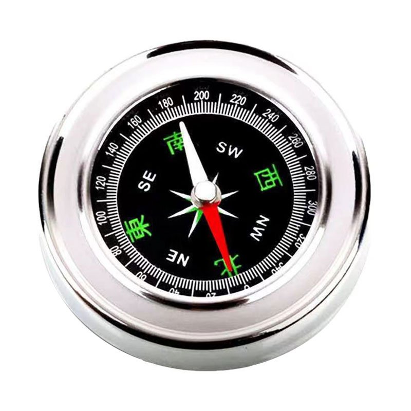 Multi-purpose portable compass metal points to a mini-multifunctional children's guide on foot outside the north
