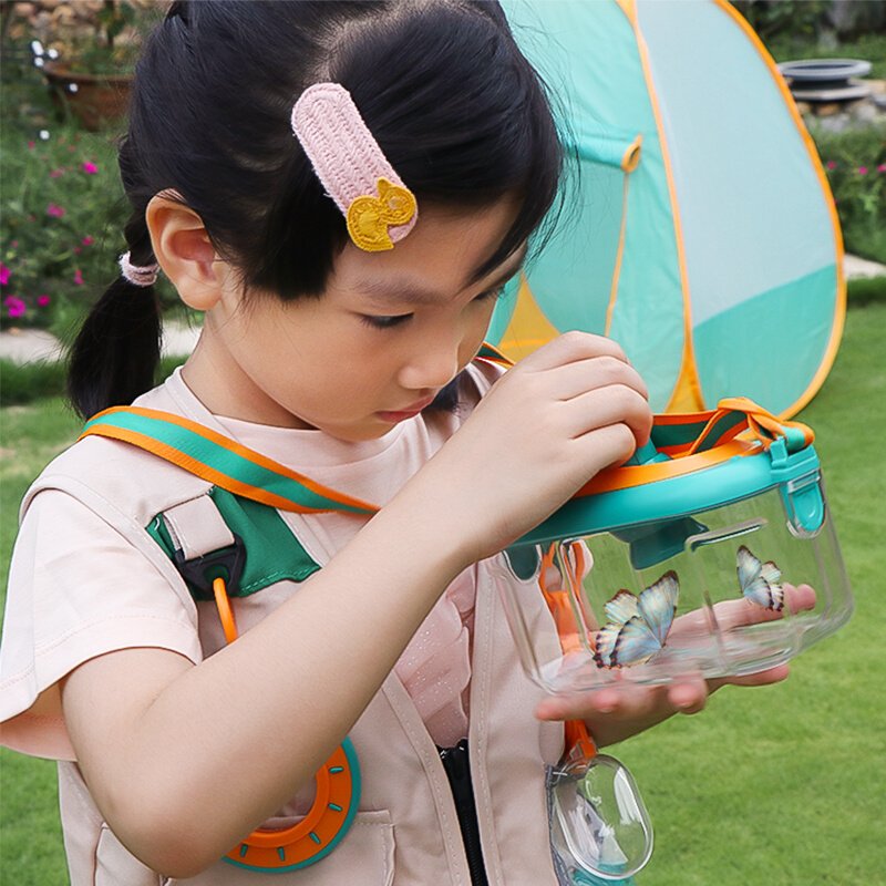 The Cora Diary Insects Watchbox Children's Guide Boy outdoors explore a magnifying glass toy trap