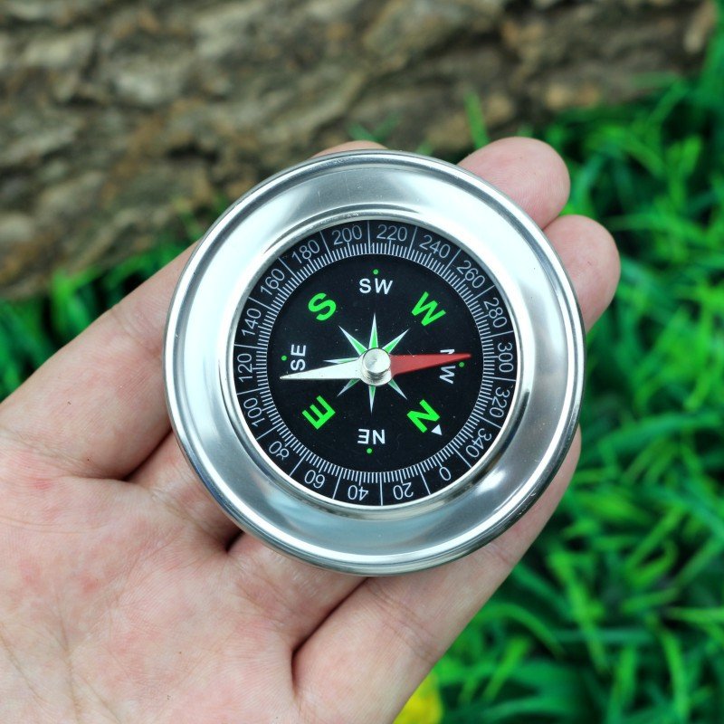 The stainless steel compass points to the high-precision mini-carriage of a student's compass in an outdoor-equipmented school car