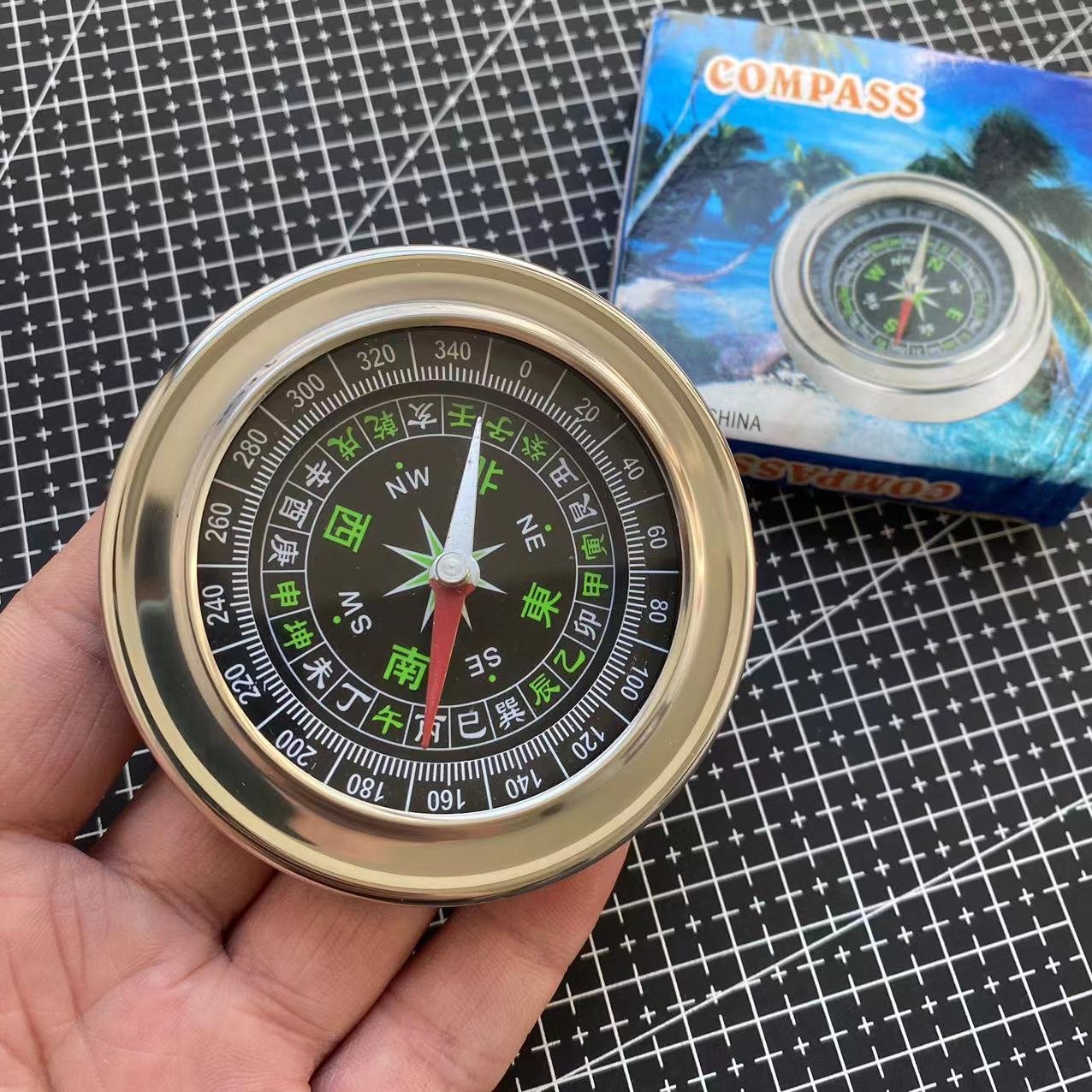The Rusty Steel Large Chinese Guides Explorer points to a compass pointing to the building of an outreach facility for the Northern Outfield Travel Group