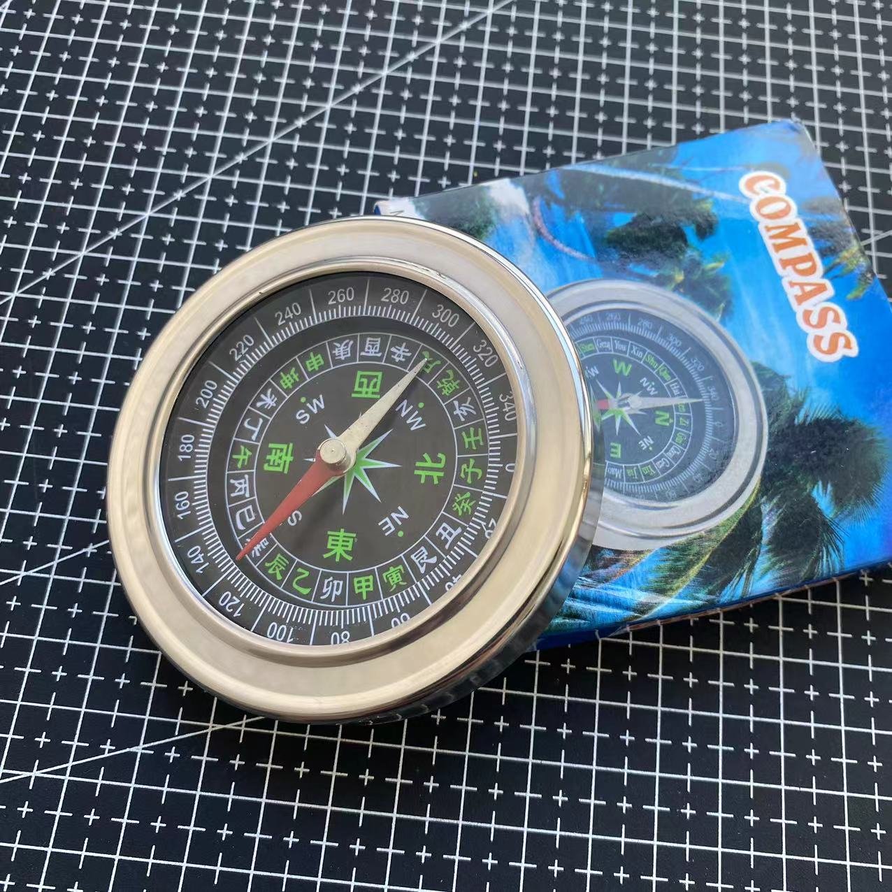The Rusty Steel Large Chinese Guides Explorer points to a compass pointing to the building of an outreach facility for the Northern Outfield Travel Group