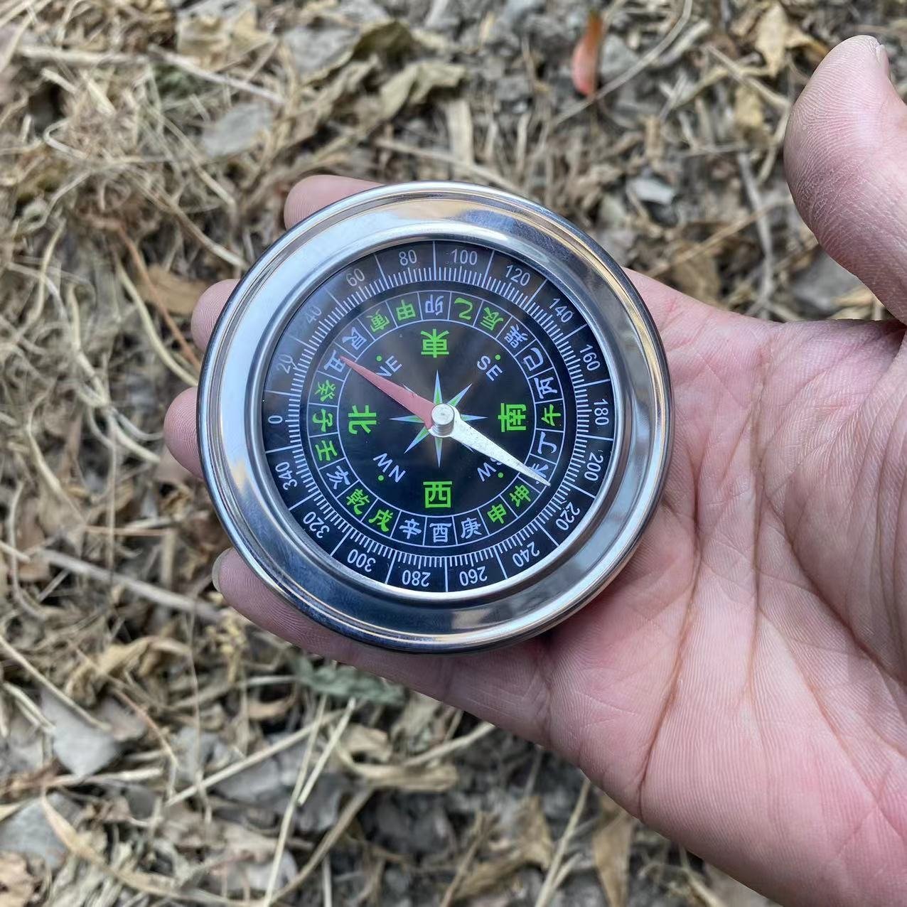 The Rusty Steel Large Chinese Guides Explorer points to a compass pointing to the building of an outreach facility for the Northern Outfield Travel Group