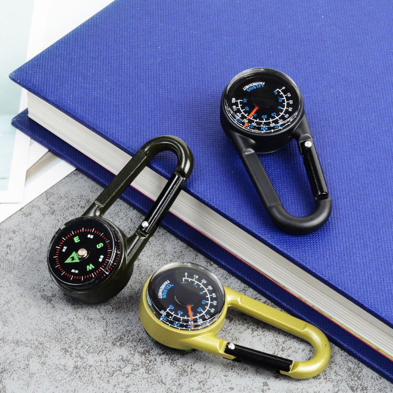 An outdoor high-precision hickey points to a northerly compass thermometer showing a multifunctional waterproof fast-mounted compass