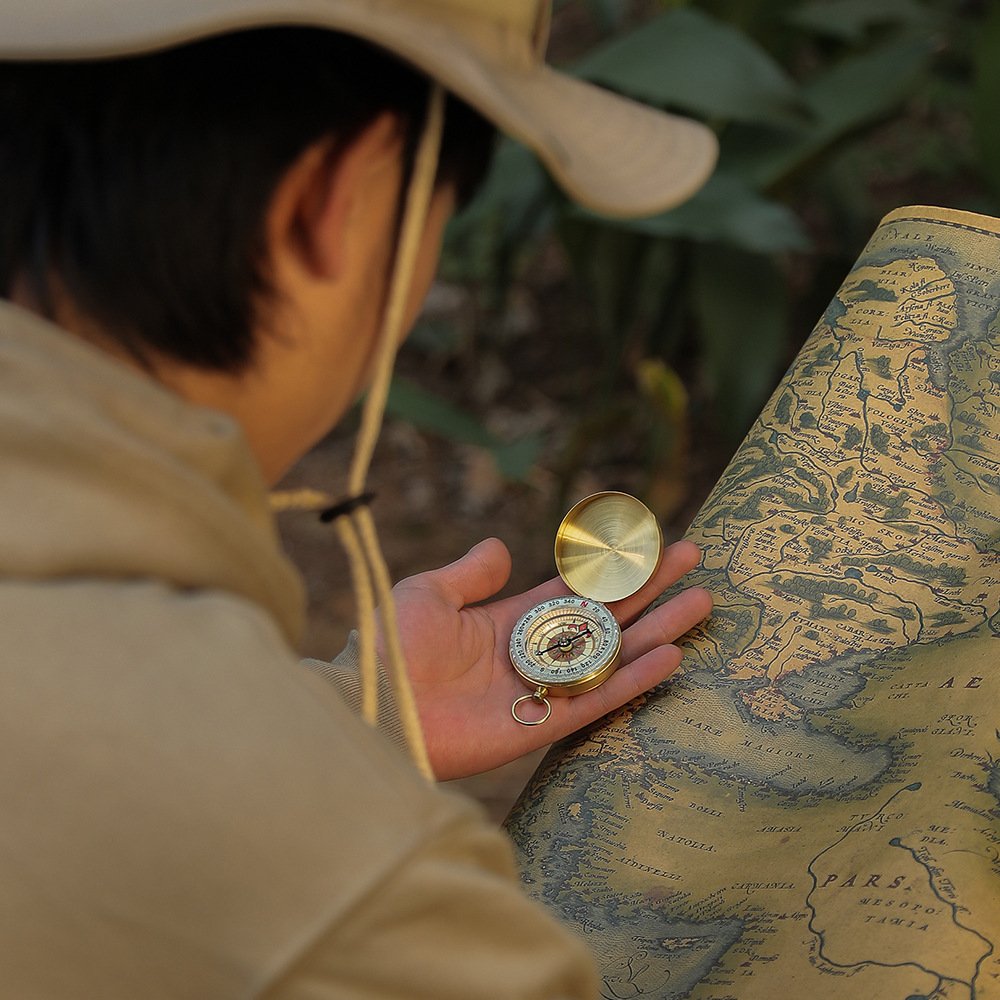complimentary gift-ordered logo outdoors with a map of the night-lighted gold compass company