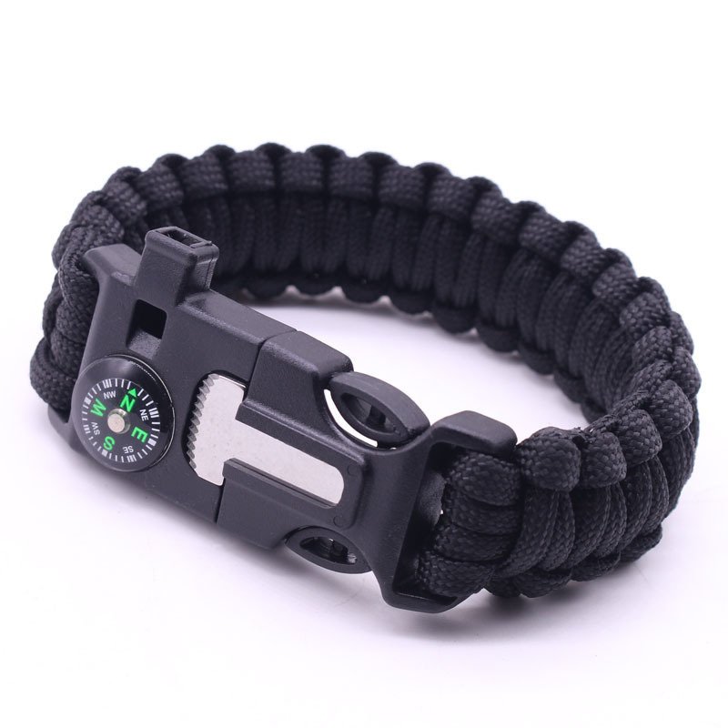 An outdoor hiking bracelet with a multi-purpose umbrella line and a five-to-one compass