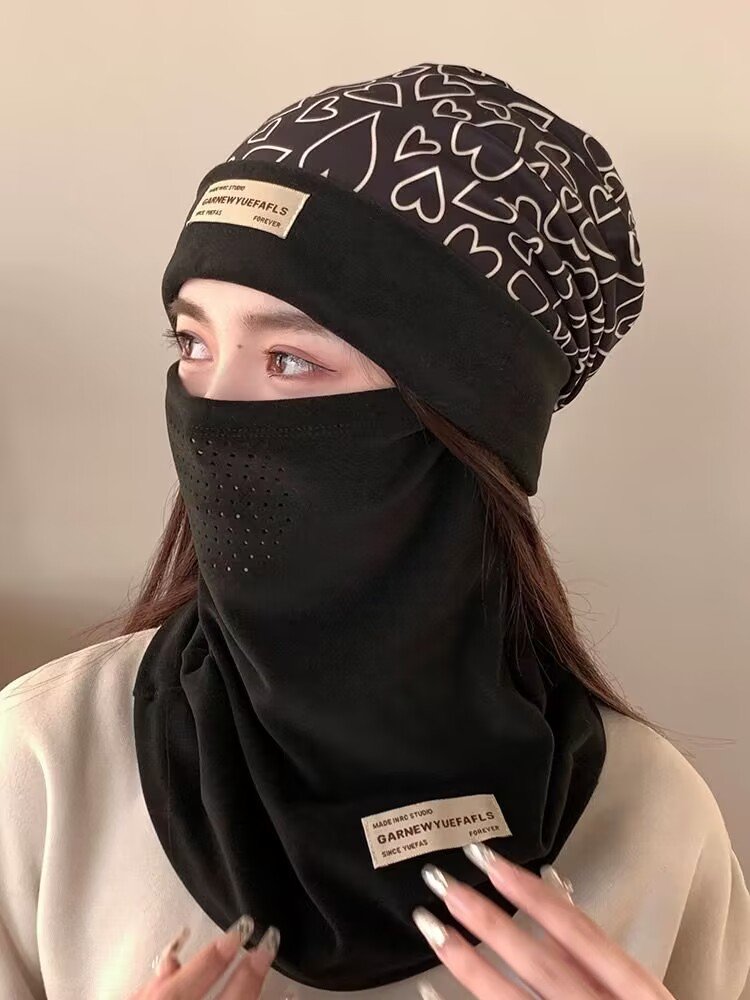 Ski masked woman with a turban with a thick hood on her face in the autumn and winter