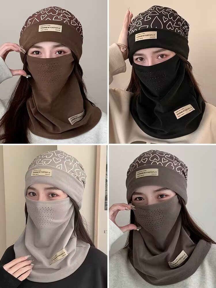Ski masked woman with a turban with a thick hood on her face in the autumn and winter