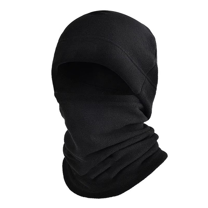 In winter, a woman with a warm head cap rides an electric car around with a decent ski mask and a cold neck scarf