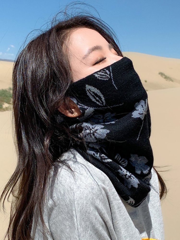 She's on a winter out-of-house trip, wearing a wind and heat hood with a thick scarf to protect her neck
