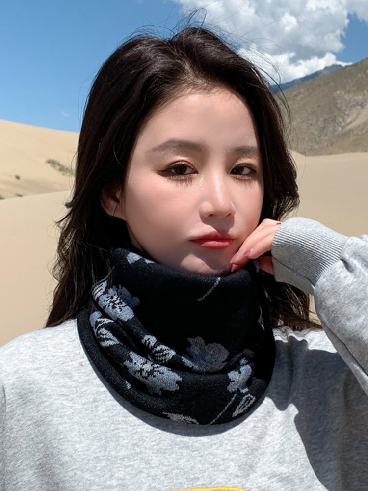 She's on a winter out-of-house trip, wearing a wind and heat hood with a thick scarf to protect her neck