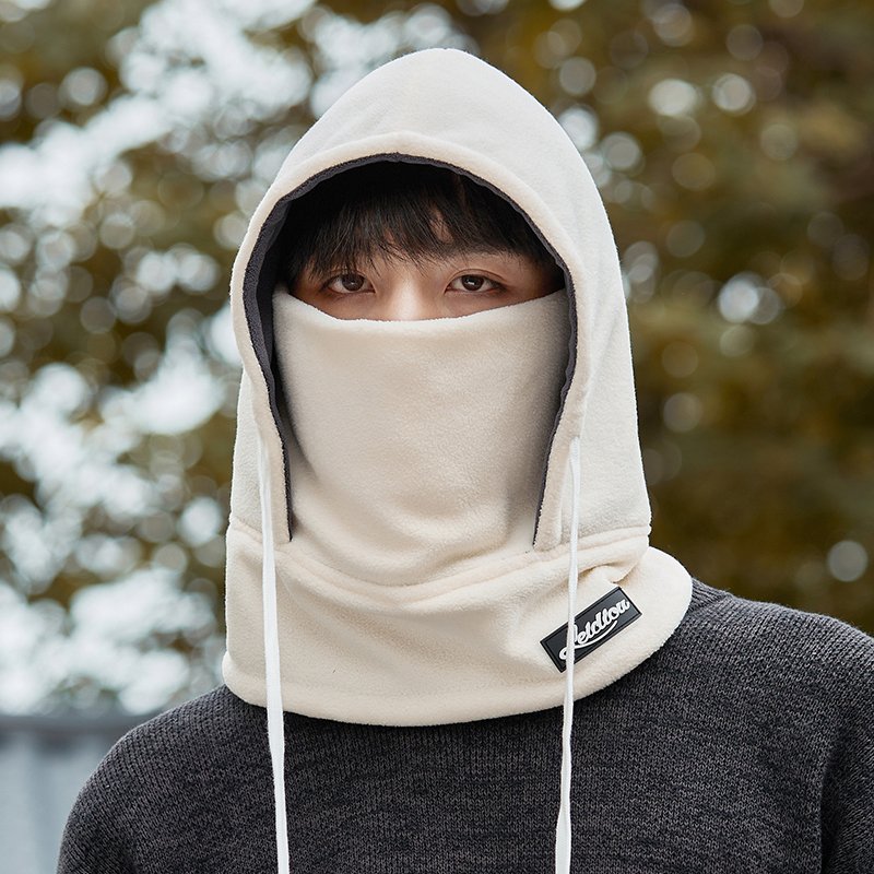 Frozen hat man rides in winter with a thick heated mask to cover his ear and head with a ricket to protect him from the cold
