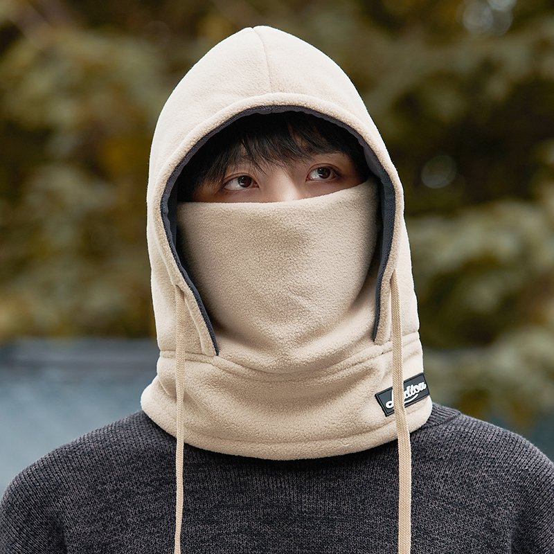 Frozen hat man rides in winter with a thick heated mask to cover his ear and head with a ricket to protect him from the cold