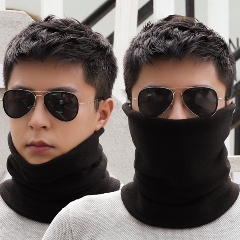 The hooded man warms himself in winter and warms his neck in winter