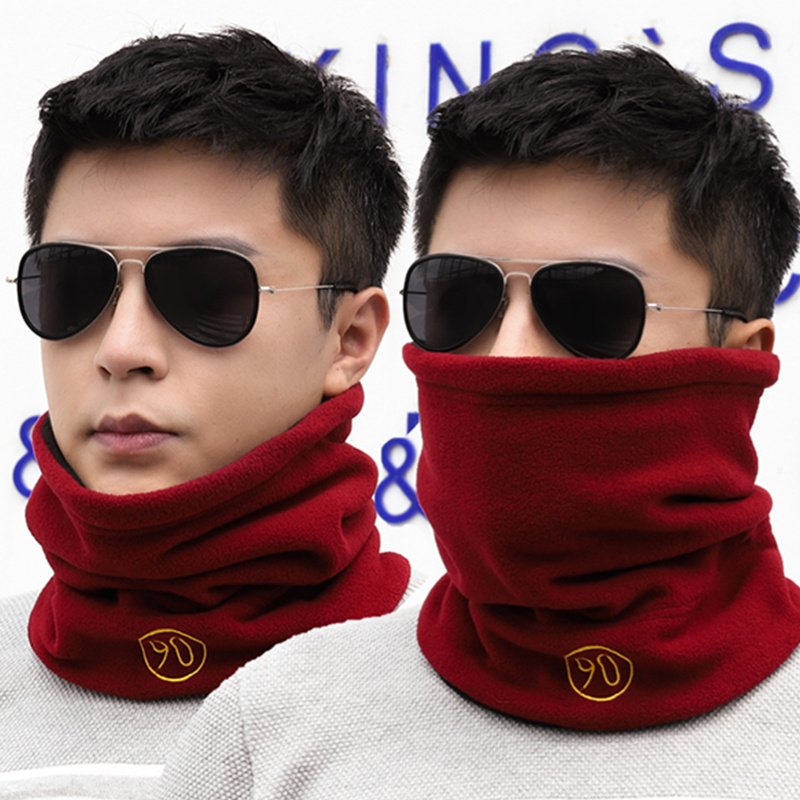 The hooded man warms himself in winter and warms his neck in winter