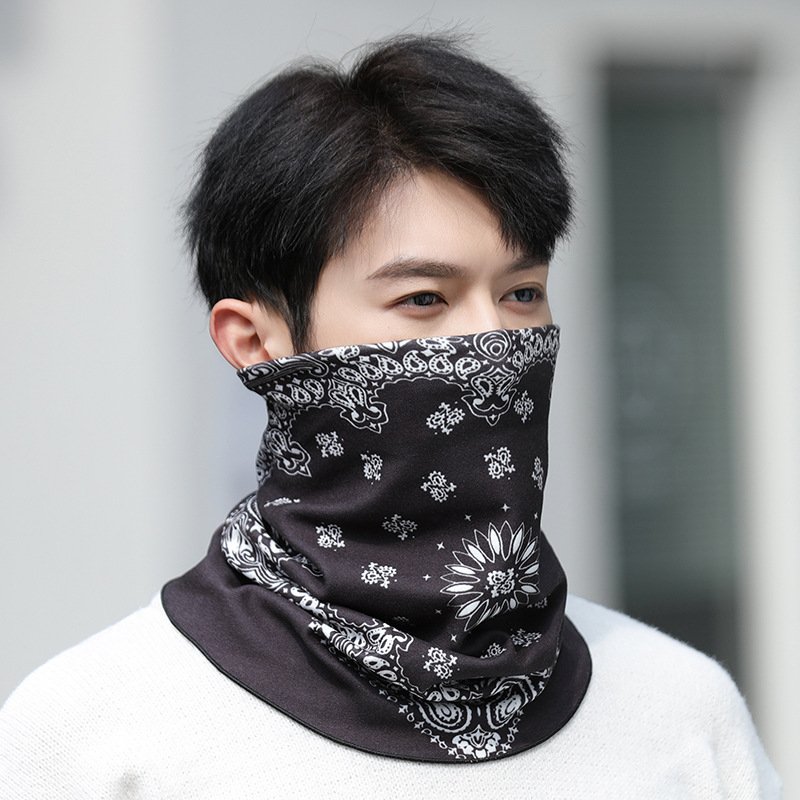 Riding a face mask around a snowman's skiing winter windy up the mountain to keep his face warm and his face warm