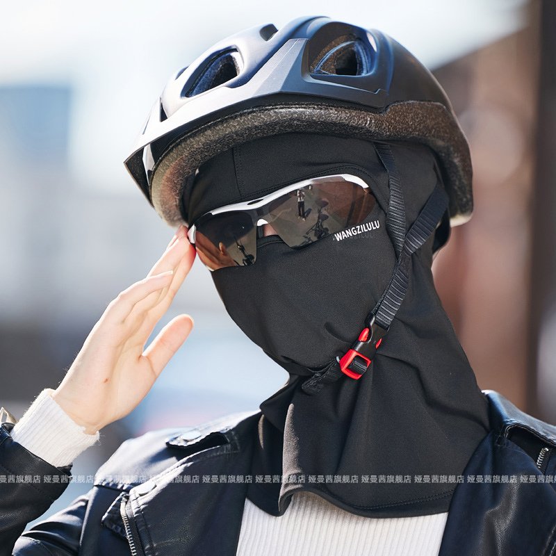 The woman with the wind bag hat rides on her face during the winter