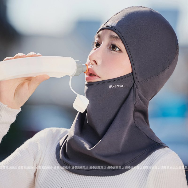 The woman with the wind bag hat rides on her face during the winter