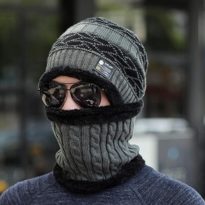 A man with a hat and a tweezer in winter and a warm, warm, cold, outdoor, cold cycling to a mountain and a winter cotton hat
