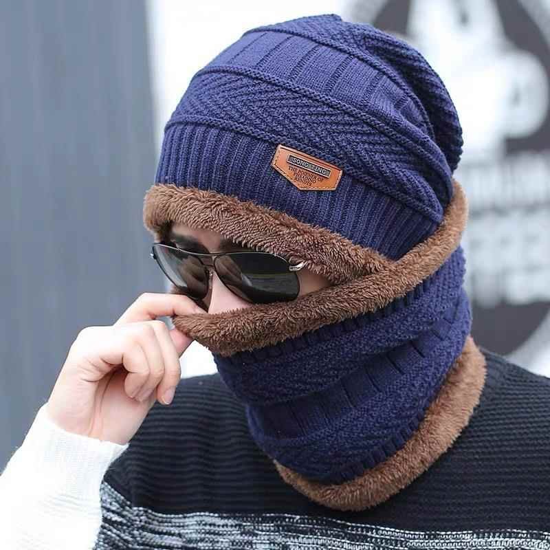 A man with a hat and a scarf to keep his neck warm