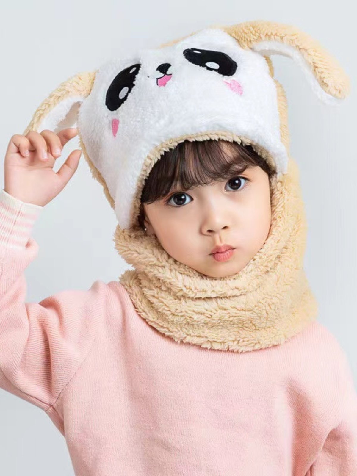 In autumn and winter, the boy and girl with the scarf and the baby with the hood and the hood
