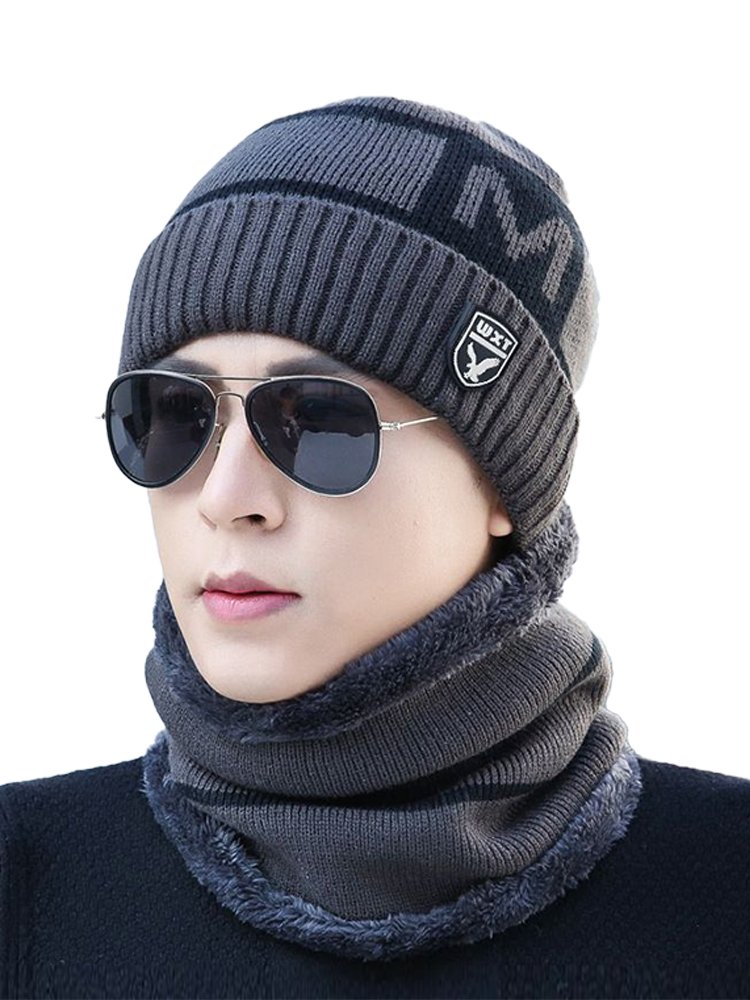A man with a hat and a wind mask for the winter ride with a velvet and a thick hood to keep his neck covered with a hood