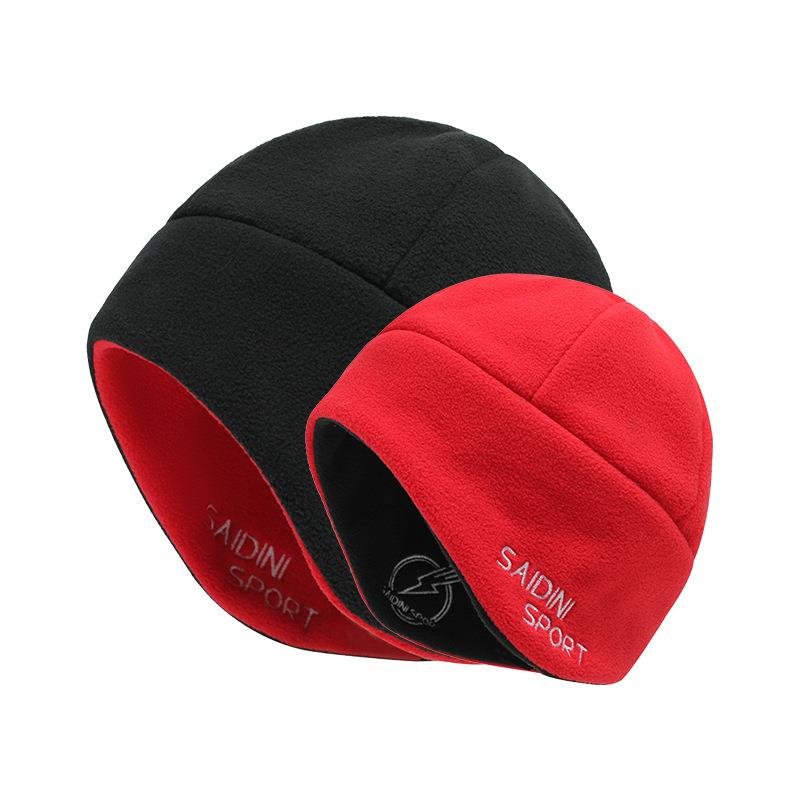 A man and a woman running around with a velvet cap and a snowcap to keep a snowcap warm and skiing