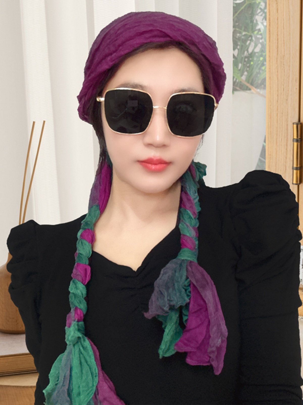 A girl with a turban on her wrinkles and a new twirl with a twirl on her neck and a twirl