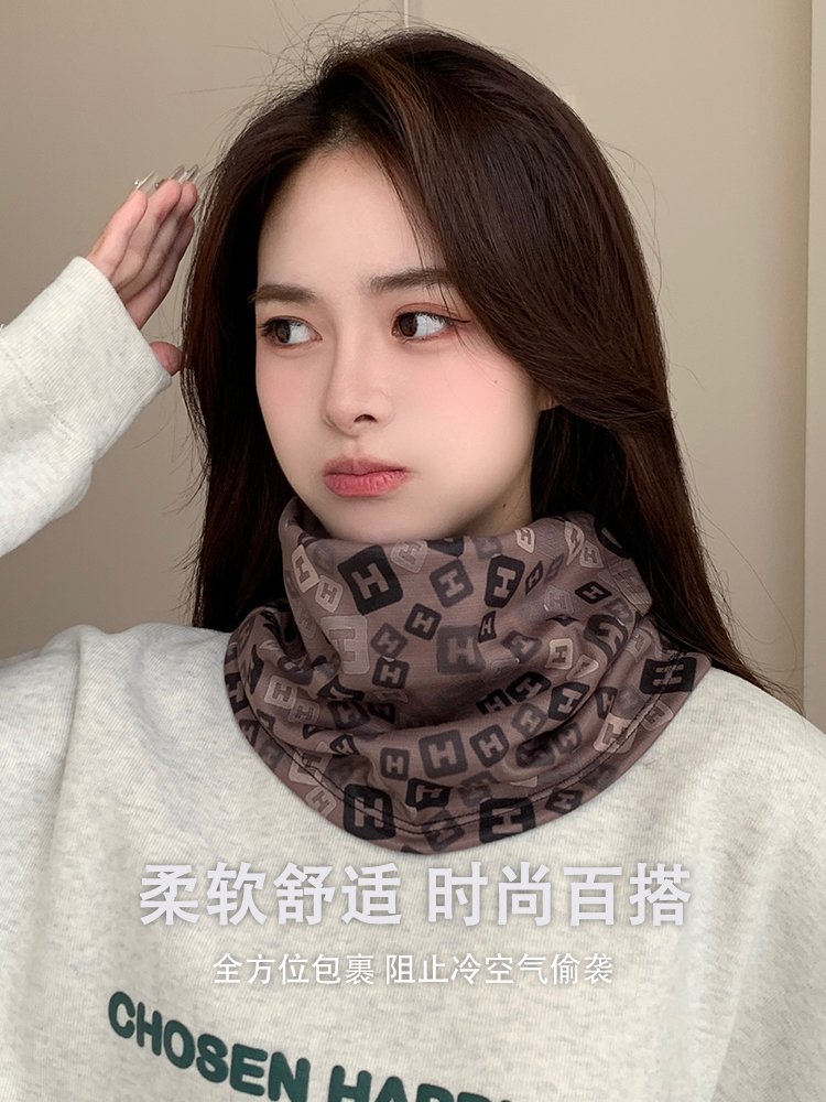 The woman with the ear mask rides the magic turban outside of the winter with the heater and thickens her neck