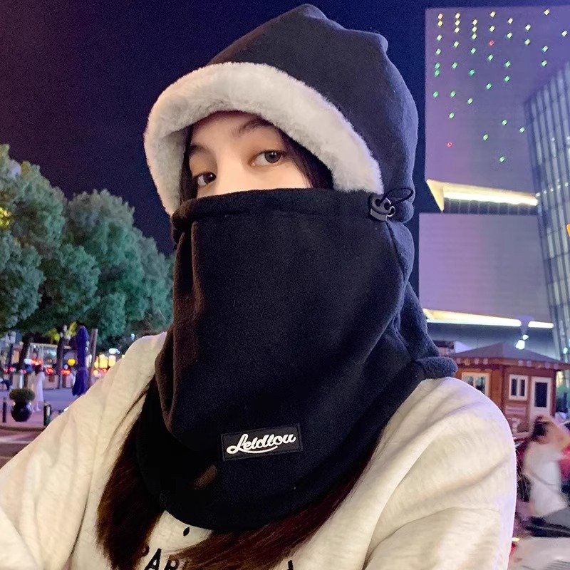 In winter, a woman with a warm head cap rides a decent ski and wind and cold scarf