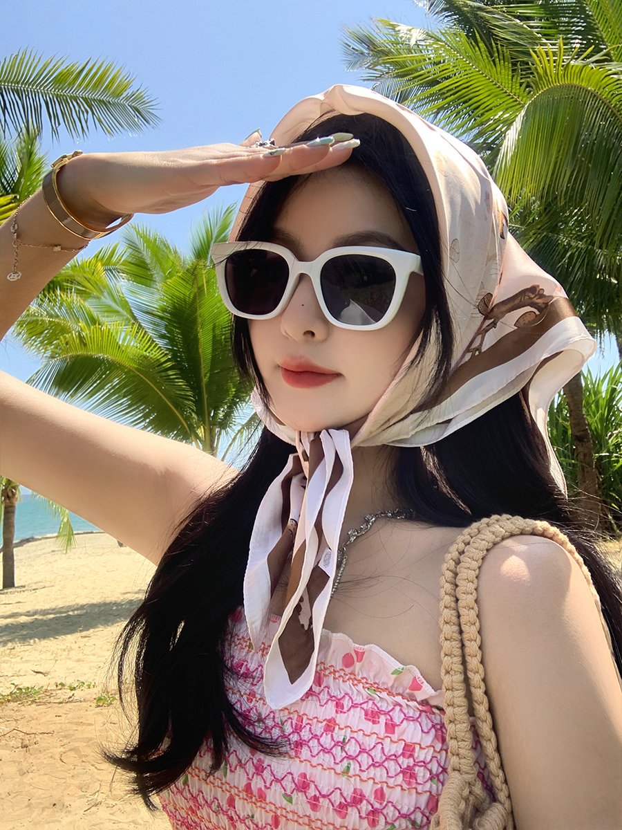 French high-sensored turban women take photos of sun towels on the beach side of the turban