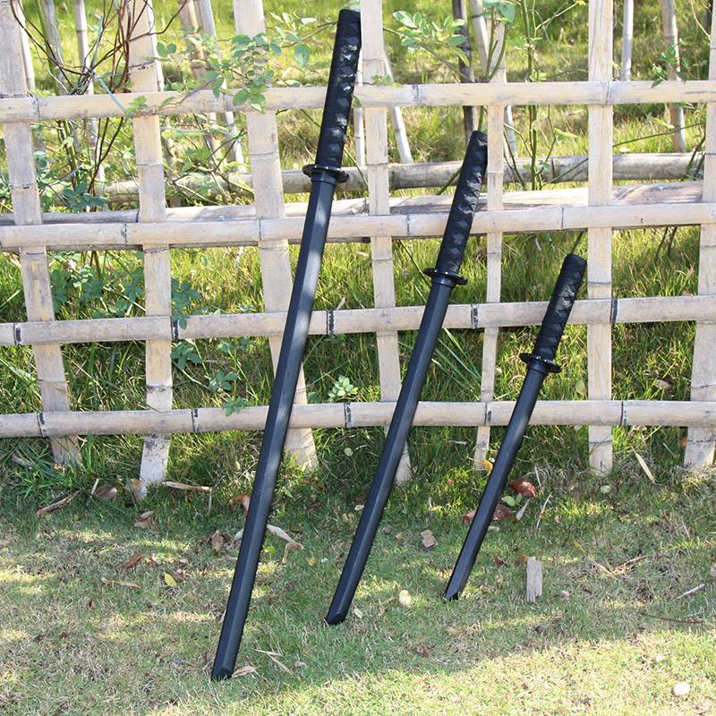 A set of three black wooden knives