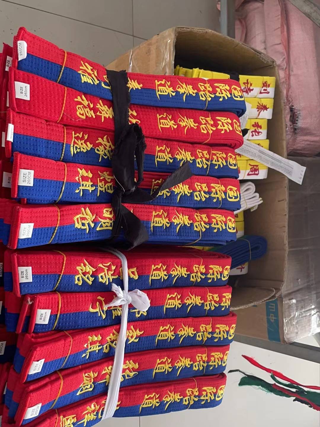 Ten packs of black-coloured, yellow-banded blue belts for the class-class participants