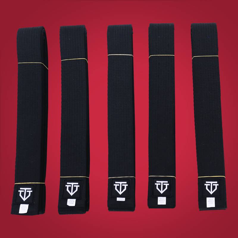 A black belt coach with a black embroidery belt customised by a black belt coach