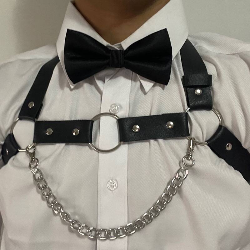 Cool, sexy guy with a laced neck and a punk corset on his shoulder with a bra and a belt on his back