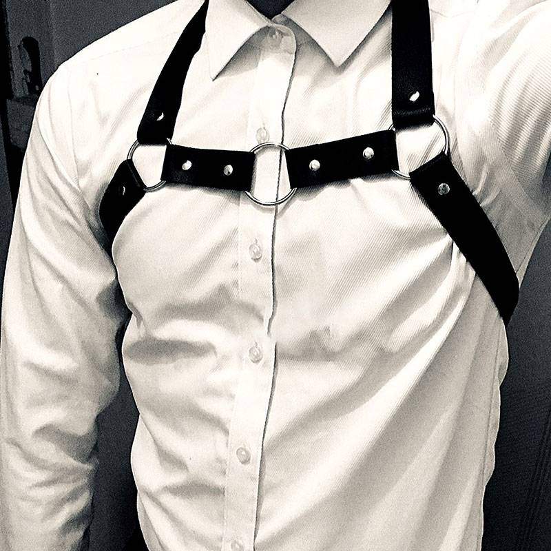 Cool, sexy guy with a laced neck and a punk corset on his shoulder with a bra and a belt on his back